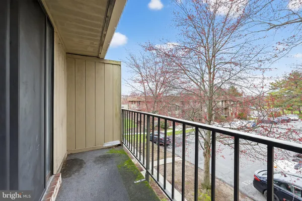 a view of a balcony with wooden fence