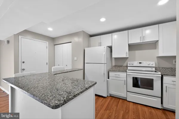 a kitchen with a stove a refrigerator and a sink
