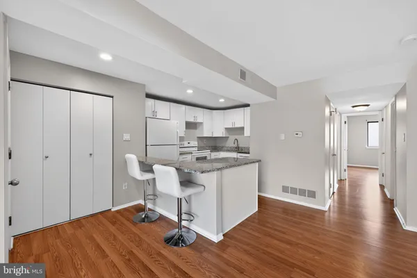a view of a kitchen from a hallway