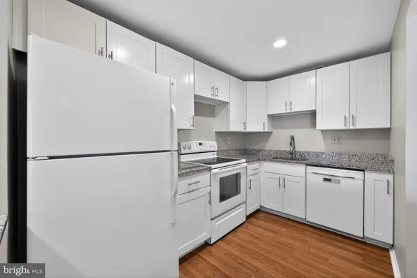 a white refrigerator freezer sitting in a kitchen