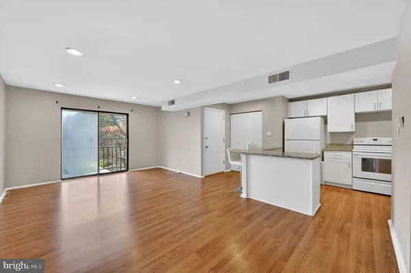 a view of kitchen with furniture and wooden floor