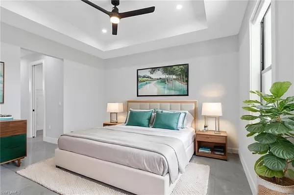 a bedroom with a bed and a potted plant