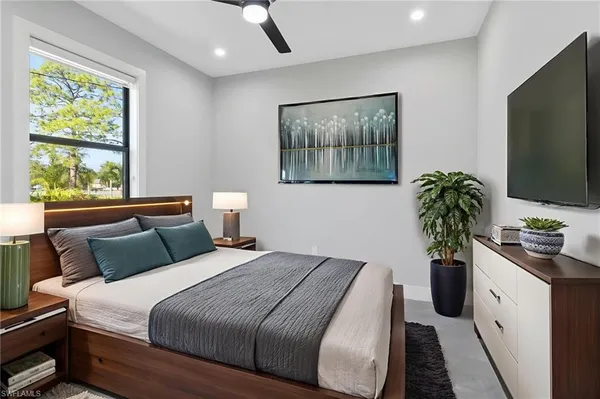 a bedroom with a bed and a flat screen tv