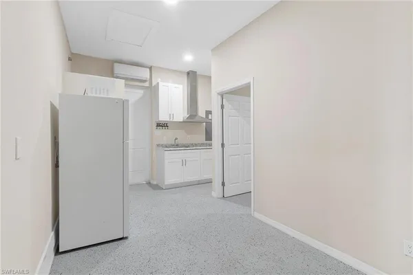 a kitchen with white cabinets and white appliances