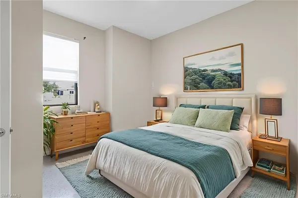 a bedroom with a bed and a window