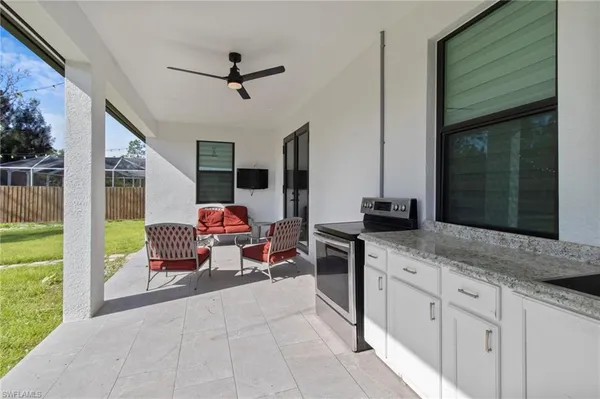a living room with stainless steel appliances kitchen island granite countertop furniture and a fireplace