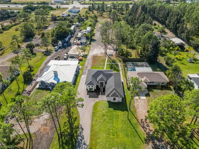 an aerial view of a house with a garden and swimming pool