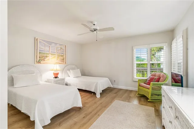a bedroom with two beds and a chandelier