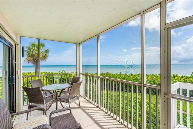a view of a chairs and table in patio with potted plants