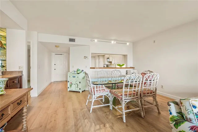 a dining room with furniture and wooden floor