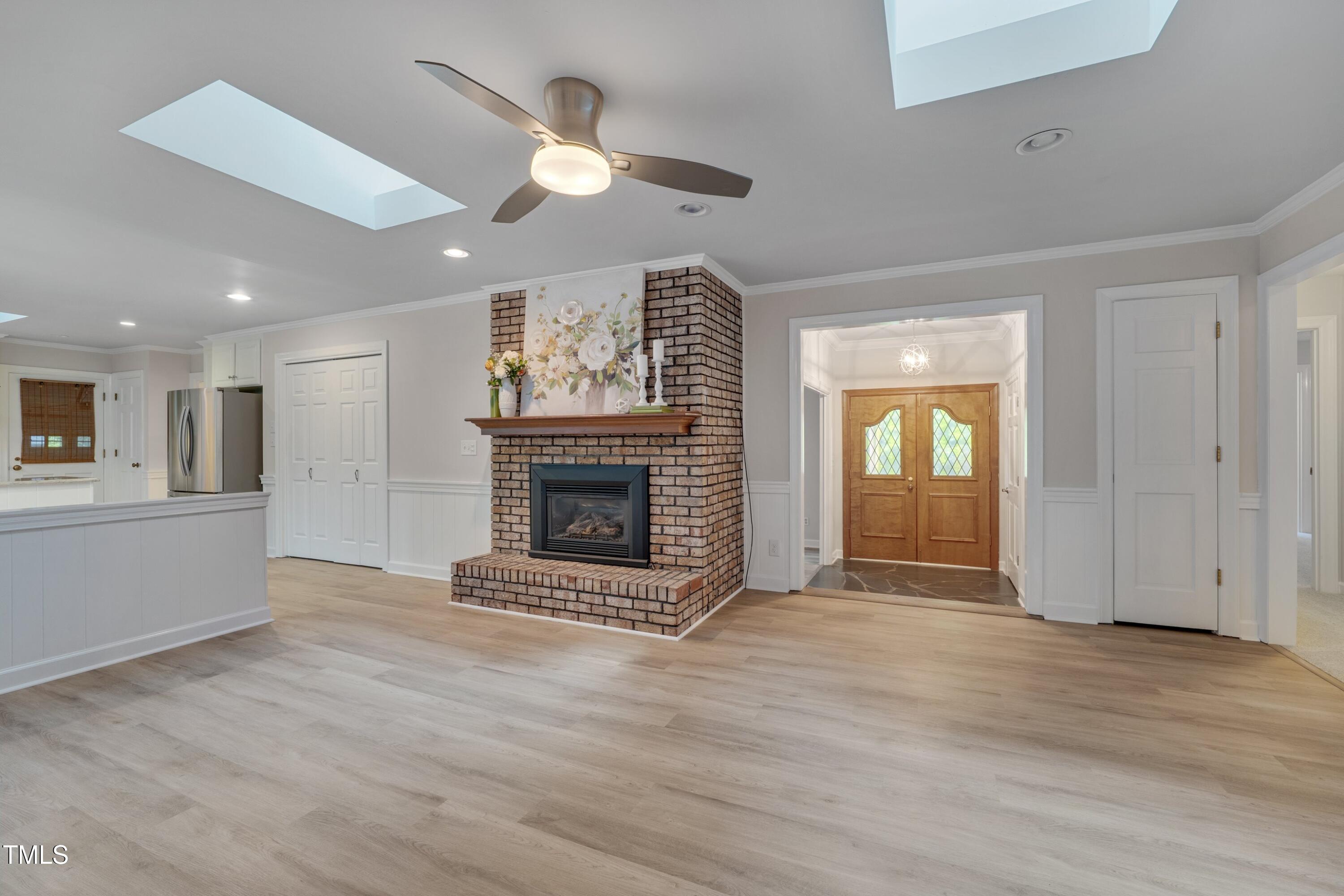 8509 Valley Brook Drive Raleigh, NC 27613 - Photo 29 of 30 Open concept floorplan with gas fireplace, double wooden doors and skylights!