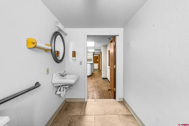 a bathroom with a glass door shower and a sink