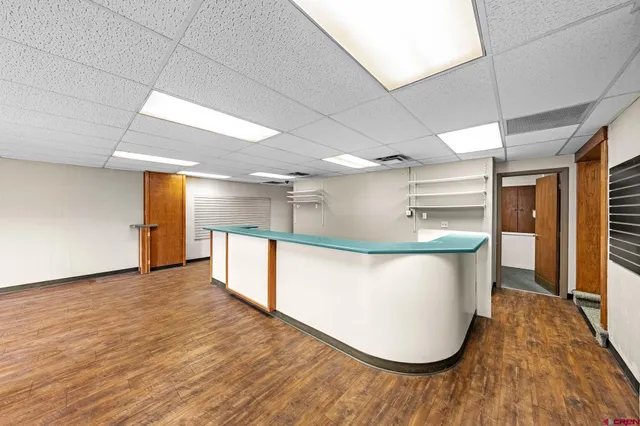 a view of a room with wooden floor