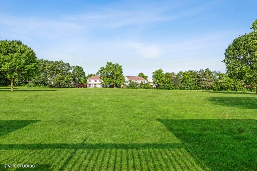 1870 Huntington Boulevard, Unit E Hoffman Estates, IL 60169 - Photo 10 of 10 a view of a garden with a building in the background
