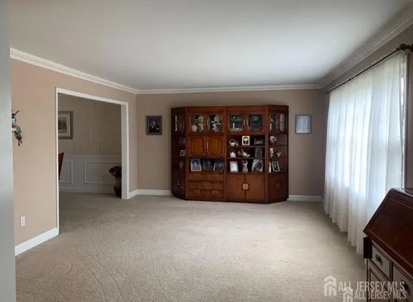 a view of an empty room with window and closet