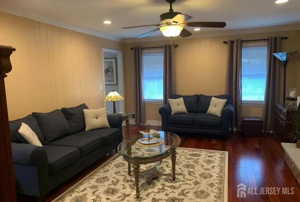 a living room with furniture and a flat screen tv