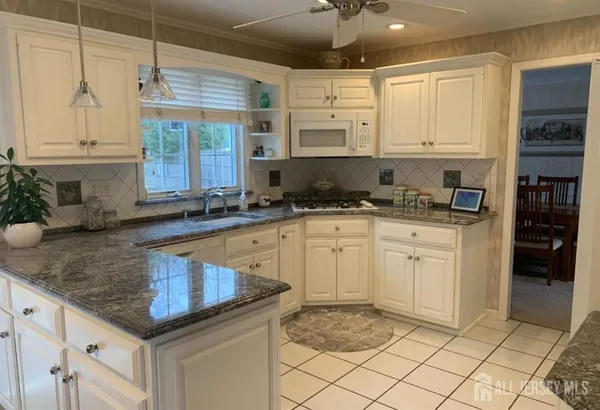 a kitchen with sink cabinets and window