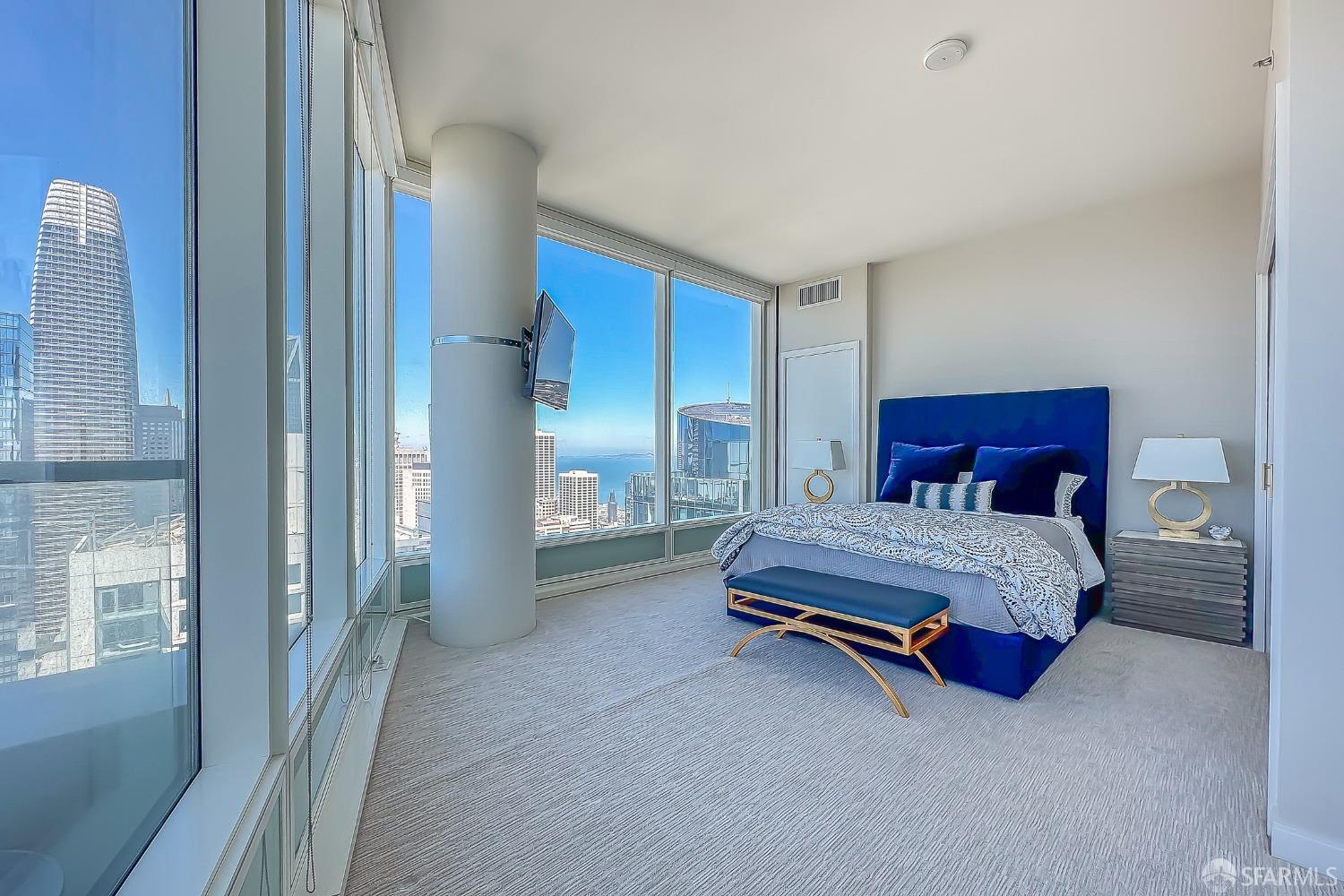 401 Harrison Street, Unit 44A San Francisco, CA 94105 - Photo 18 of 42 a spacious bedroom with a bed and a cabinets