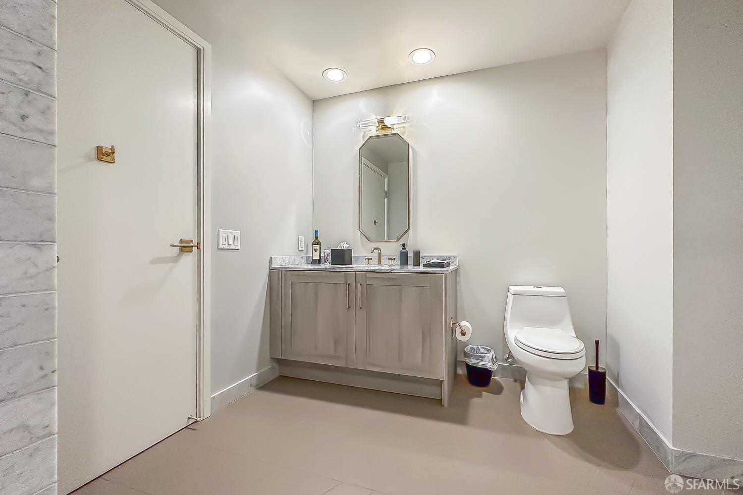 401 Harrison Street, Unit 44A San Francisco, CA 94105 - Photo 22 of 42 a bathroom with a toilet sink and mirror