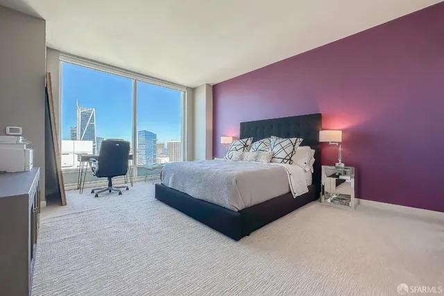 a bedroom with a bed furniture and a flat screen tv