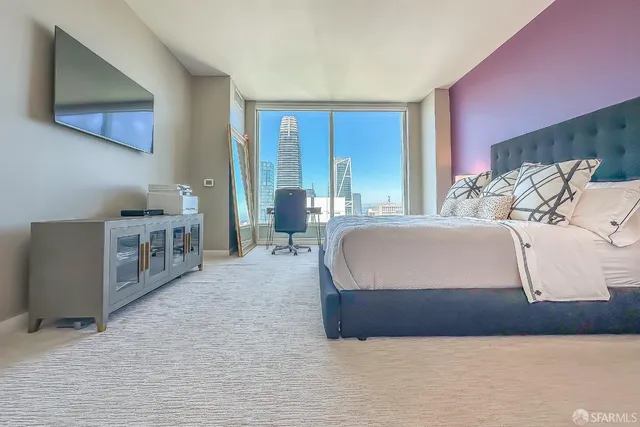 a bedroom with a bed and a potted plant