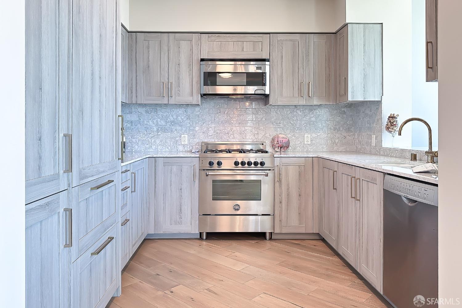 401 Harrison Street, Unit 44A San Francisco, CA 94105 - Photo 5 of 42 a kitchen with white cabinets and white appliances