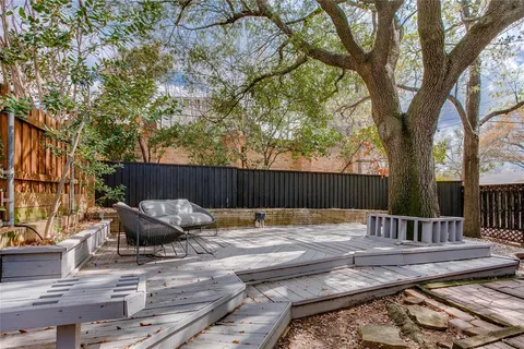 a backyard of a house with barbeque oven and outdoor seating