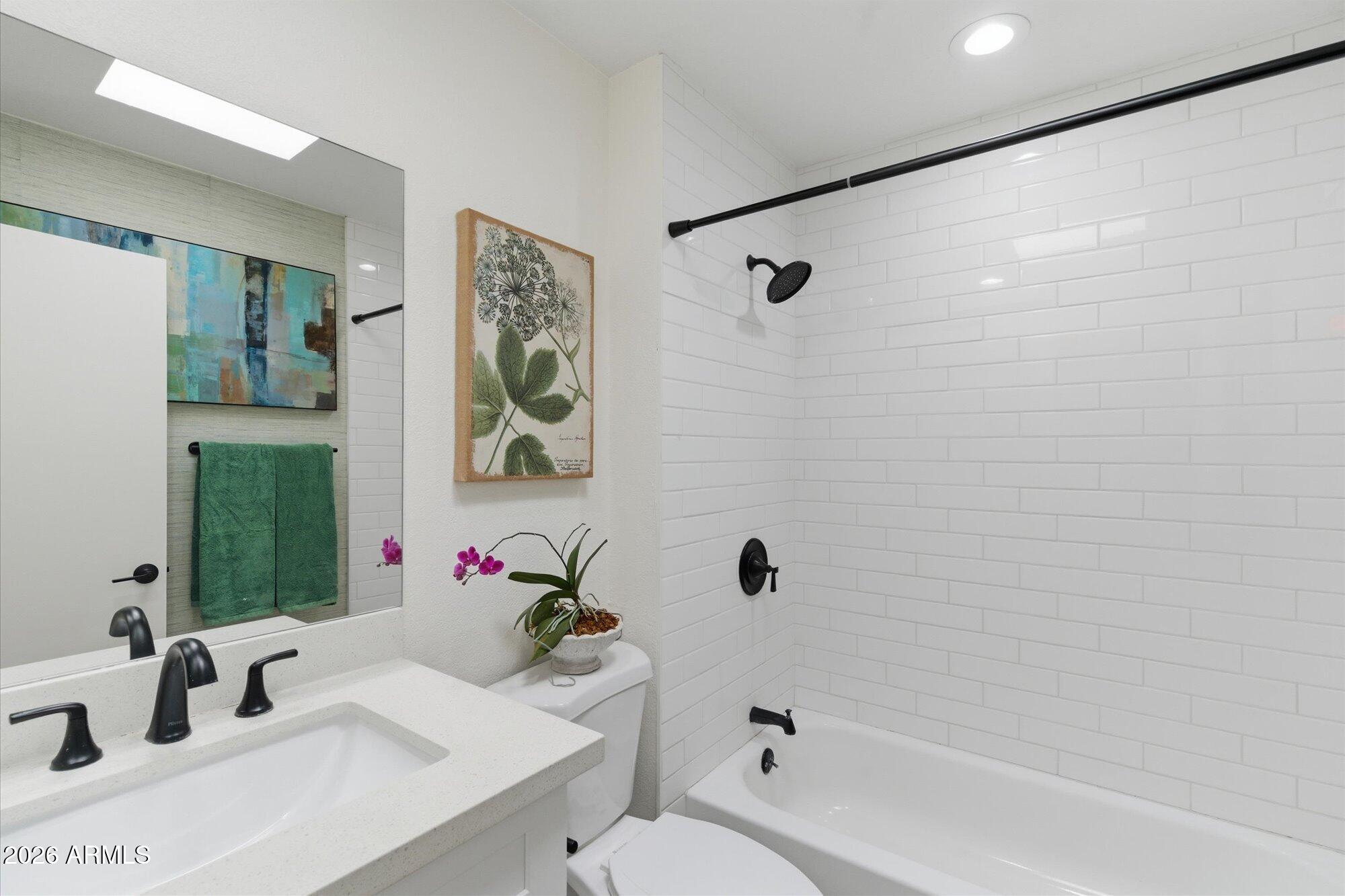 4019 East Charter Oak Road Phoenix, AZ 85032 - Photo 16 of 23 a bathroom with a sink mirror toilet and bathtub