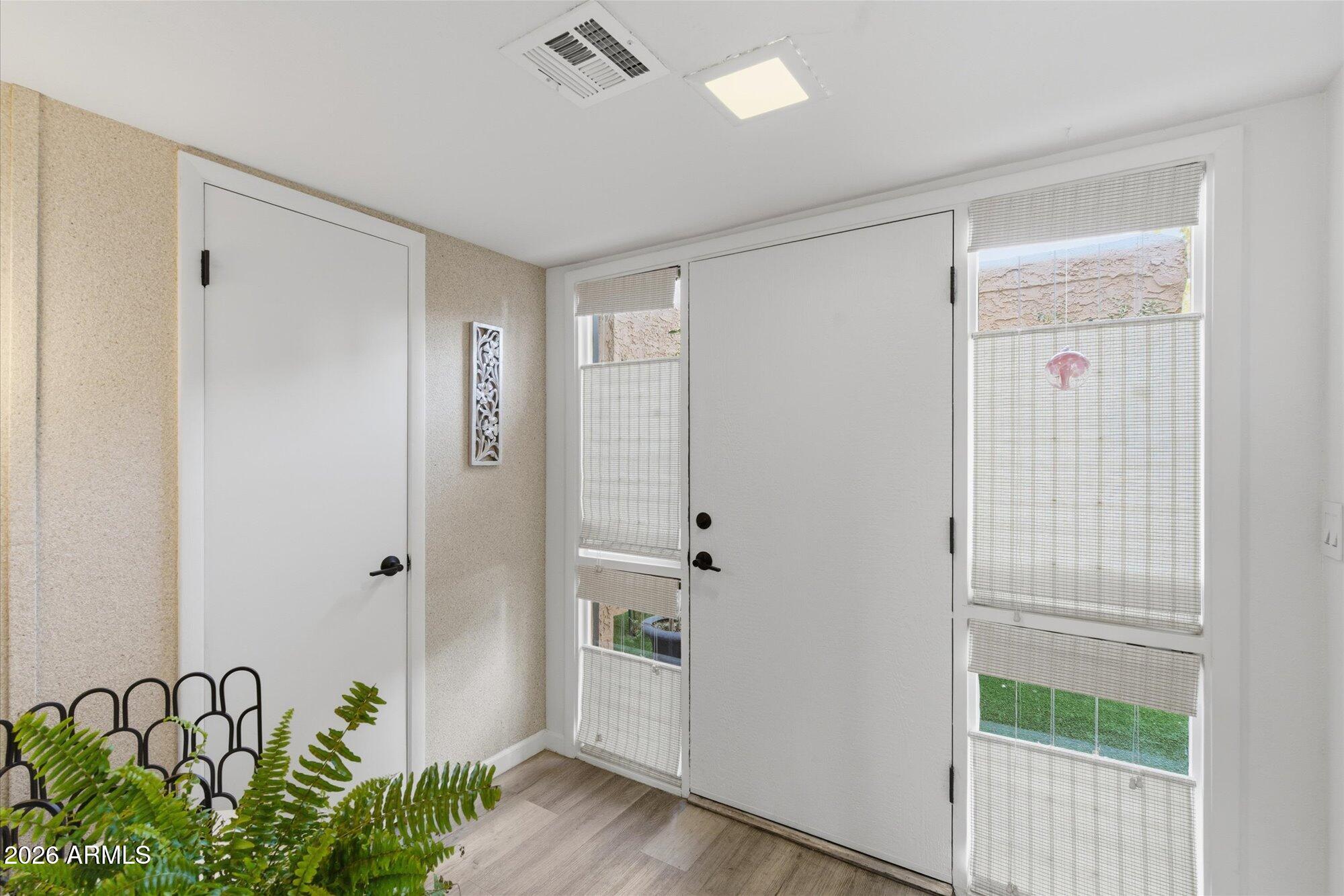4019 East Charter Oak Road Phoenix, AZ 85032 - Photo 2 of 23 a view of a hallway with wooden floor