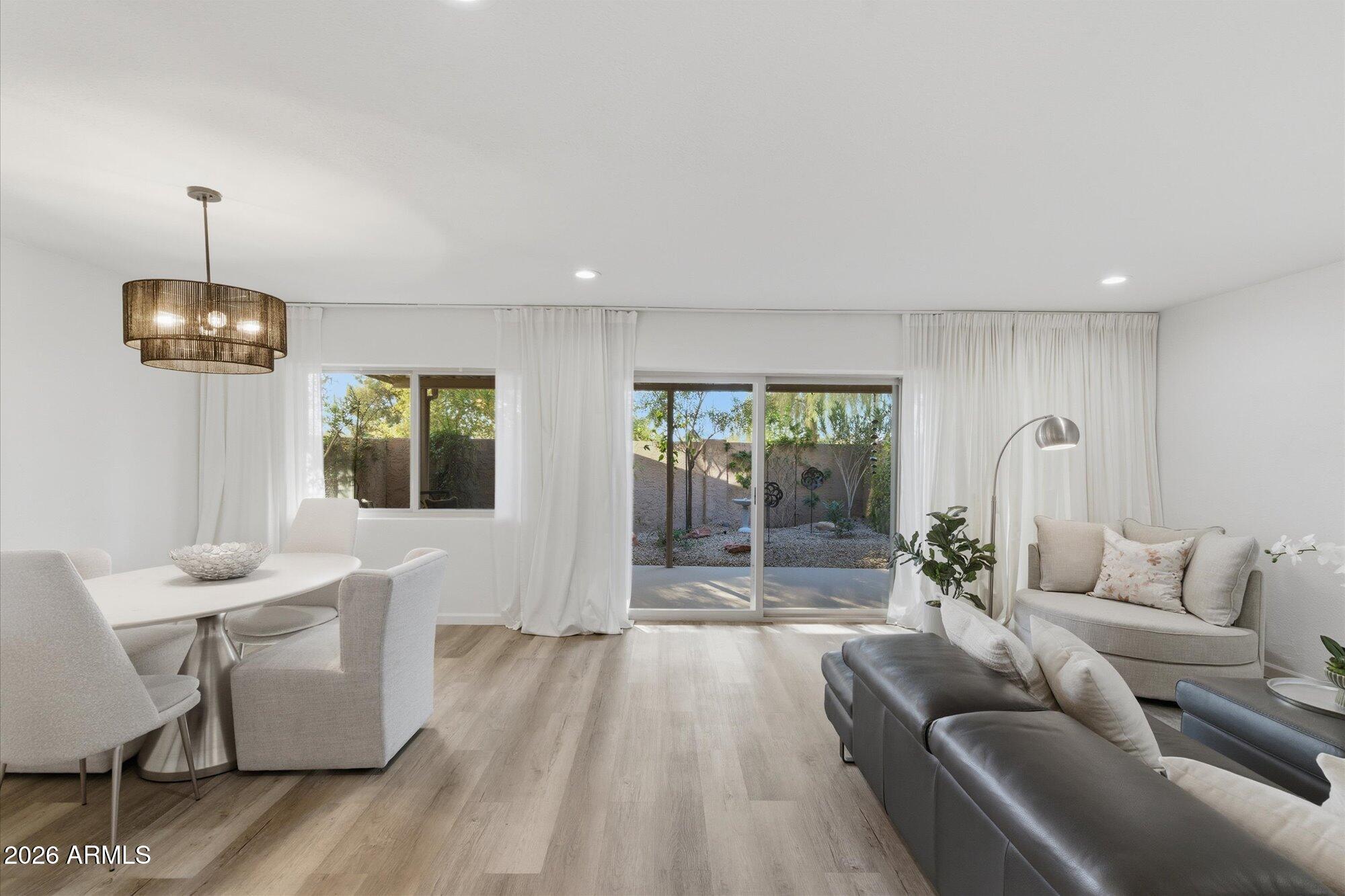 4019 East Charter Oak Road Phoenix, AZ 85032 - Photo 3 of 23 a living room with furniture and a lamp