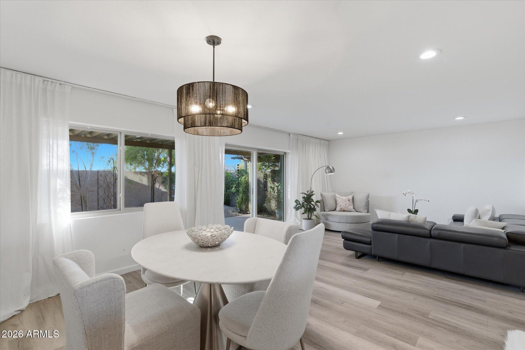 4019 East Charter Oak Road Phoenix, AZ 85032 - Photo 6 of 23 a living room with furniture and a chandelier