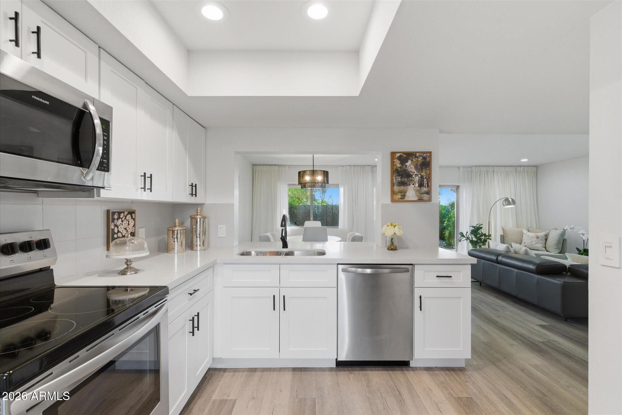 4019 East Charter Oak Road Phoenix, AZ 85032 - Photo 7 of 23 a kitchen with a sink stove and microwave
