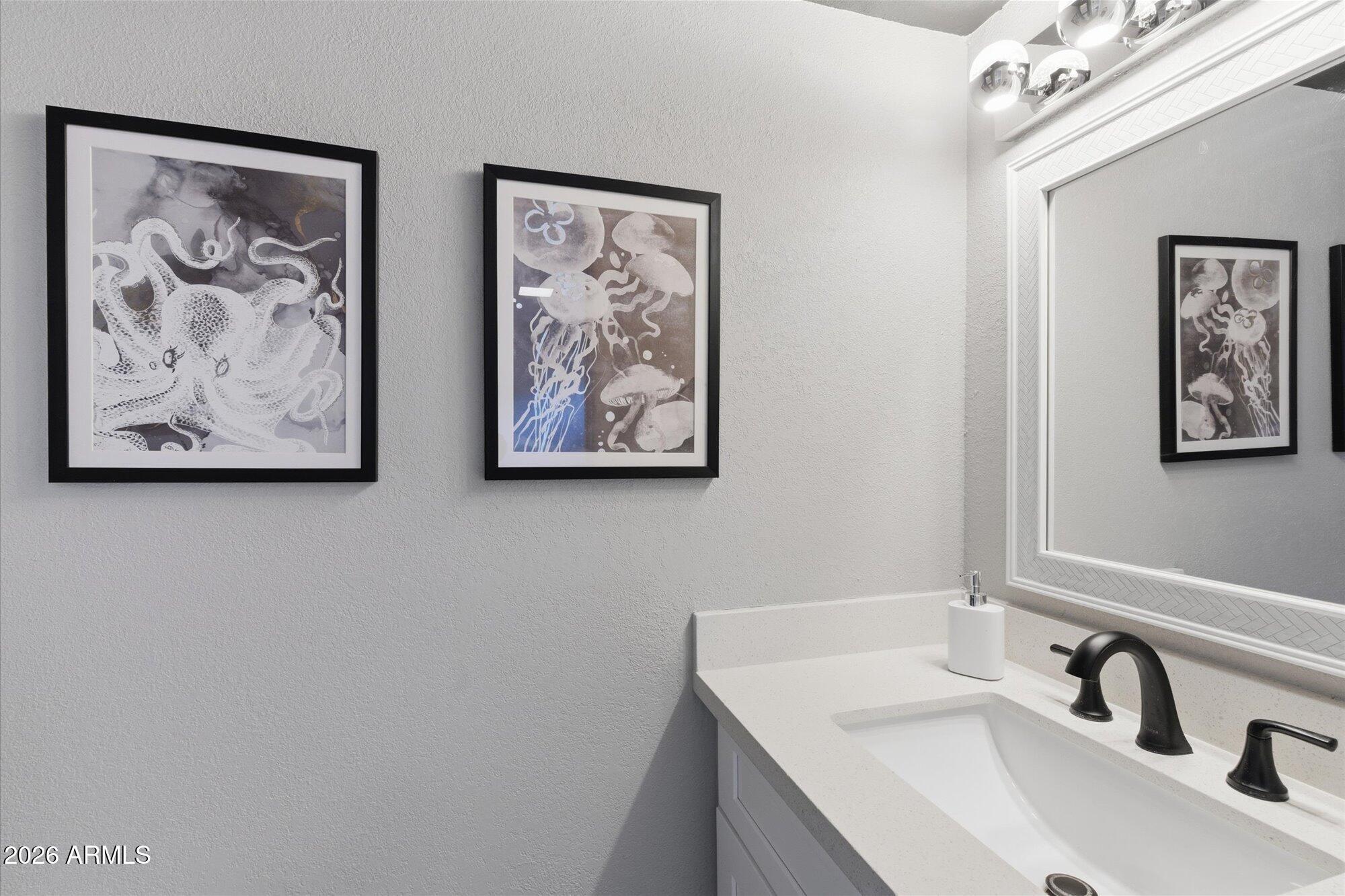 4019 East Charter Oak Road Phoenix, AZ 85032 - Photo 10 of 23 a bathroom with a sink and a mirror