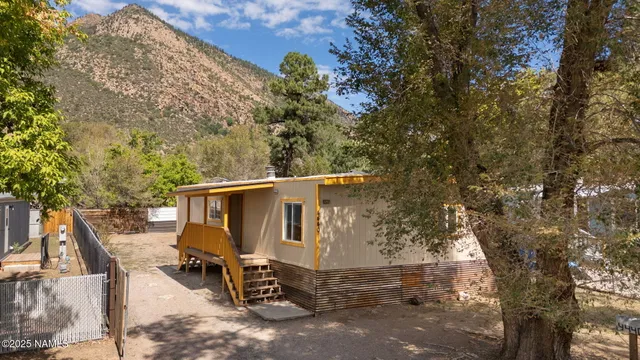an outdoor space with patio and wooden fence