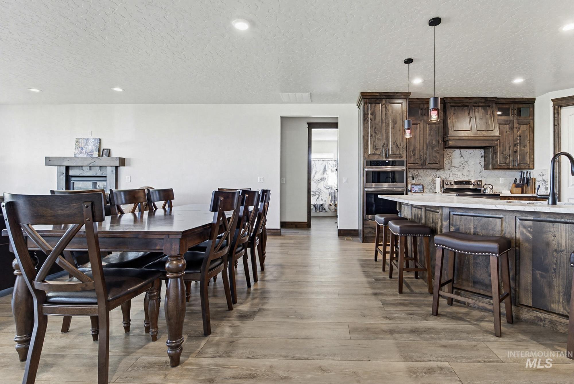 24753 Simplot Boulevard Wilder, ID 83676 - Photo 12 of 47 Dining area featuring recessed lighting, a textured ceiling, and light wood finished floors