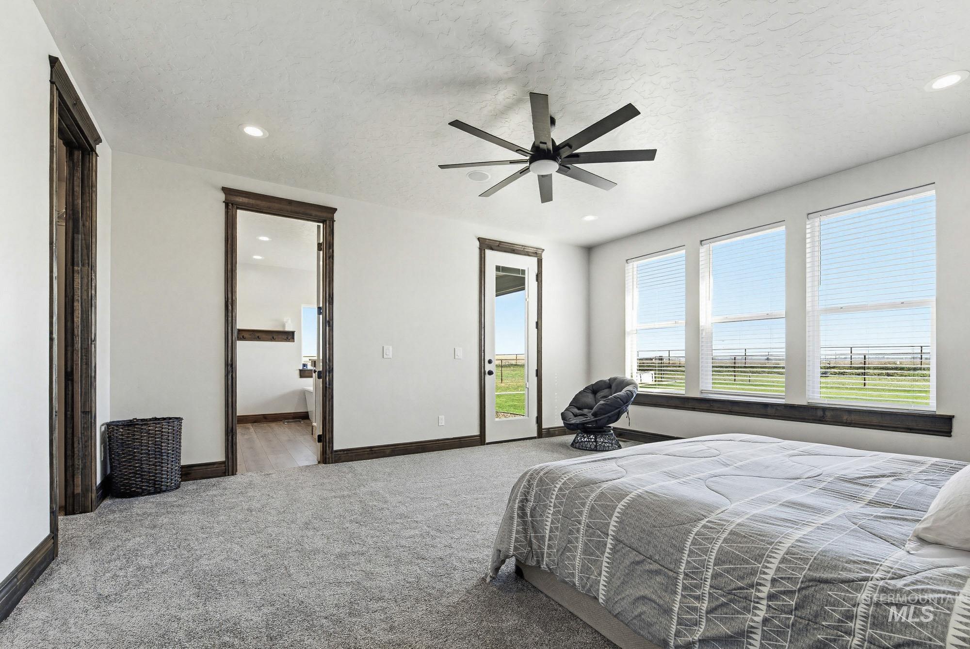 24753 Simplot Boulevard Wilder, ID 83676 - Photo 20 of 47 Carpeted bedroom featuring access to exterior, a ceiling fan, recessed lighting, a textured ceiling, and ensuite bath