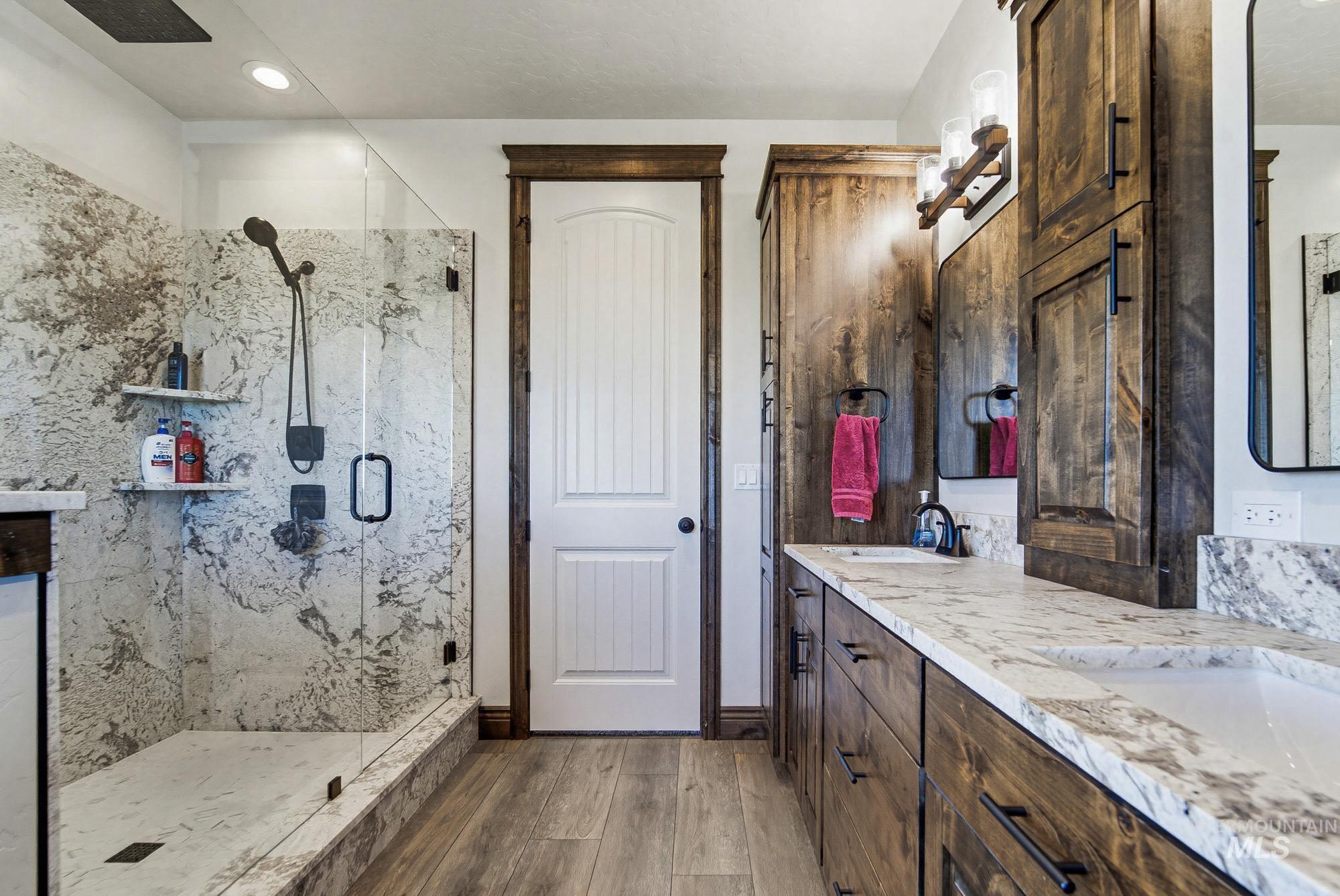 24753 Simplot Boulevard Wilder, ID 83676 - Photo 22 of 47 Full bathroom with double vanity, a marble finish shower, light wood-type flooring, and recessed lighting