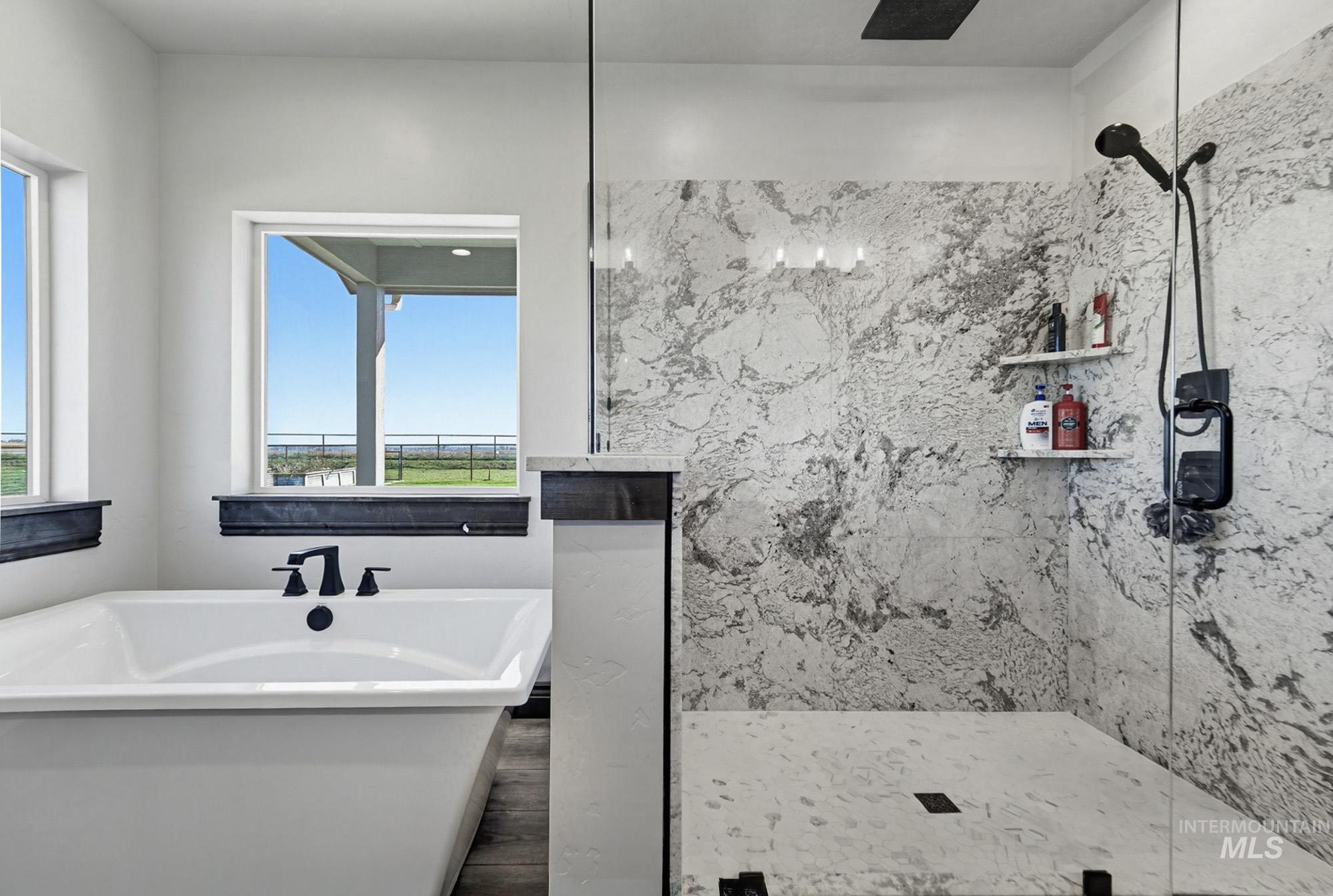 24753 Simplot Boulevard Wilder, ID 83676 - Photo 24 of 47 Full bathroom featuring a marble finish shower, plenty of natural light, a freestanding tub, and wood finished floors
