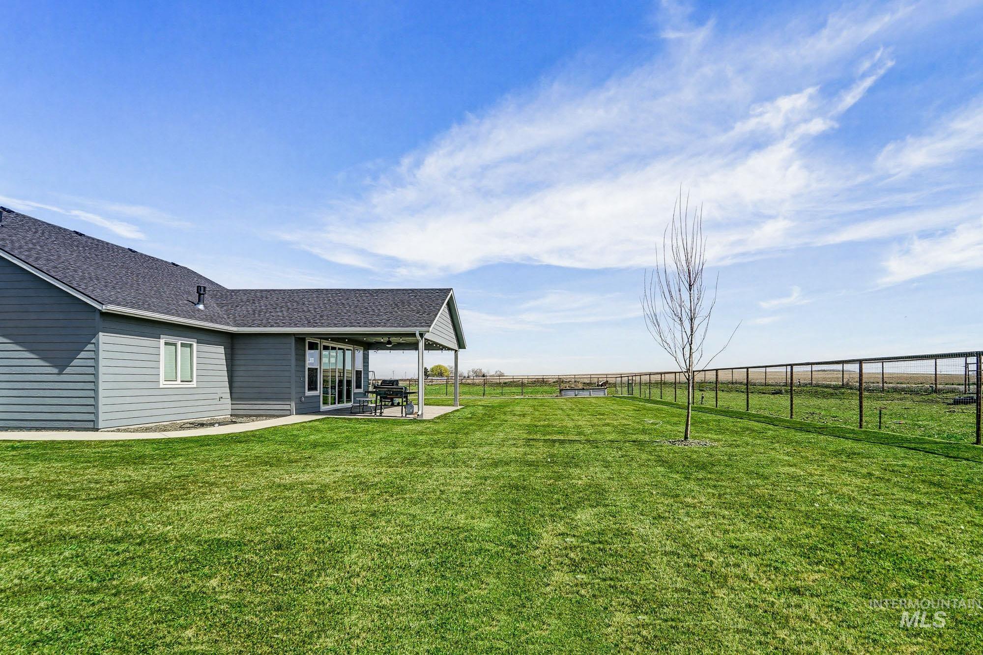 24753 Simplot Boulevard Wilder, ID 83676 - Photo 39 of 47 Fenced backyard with a patio