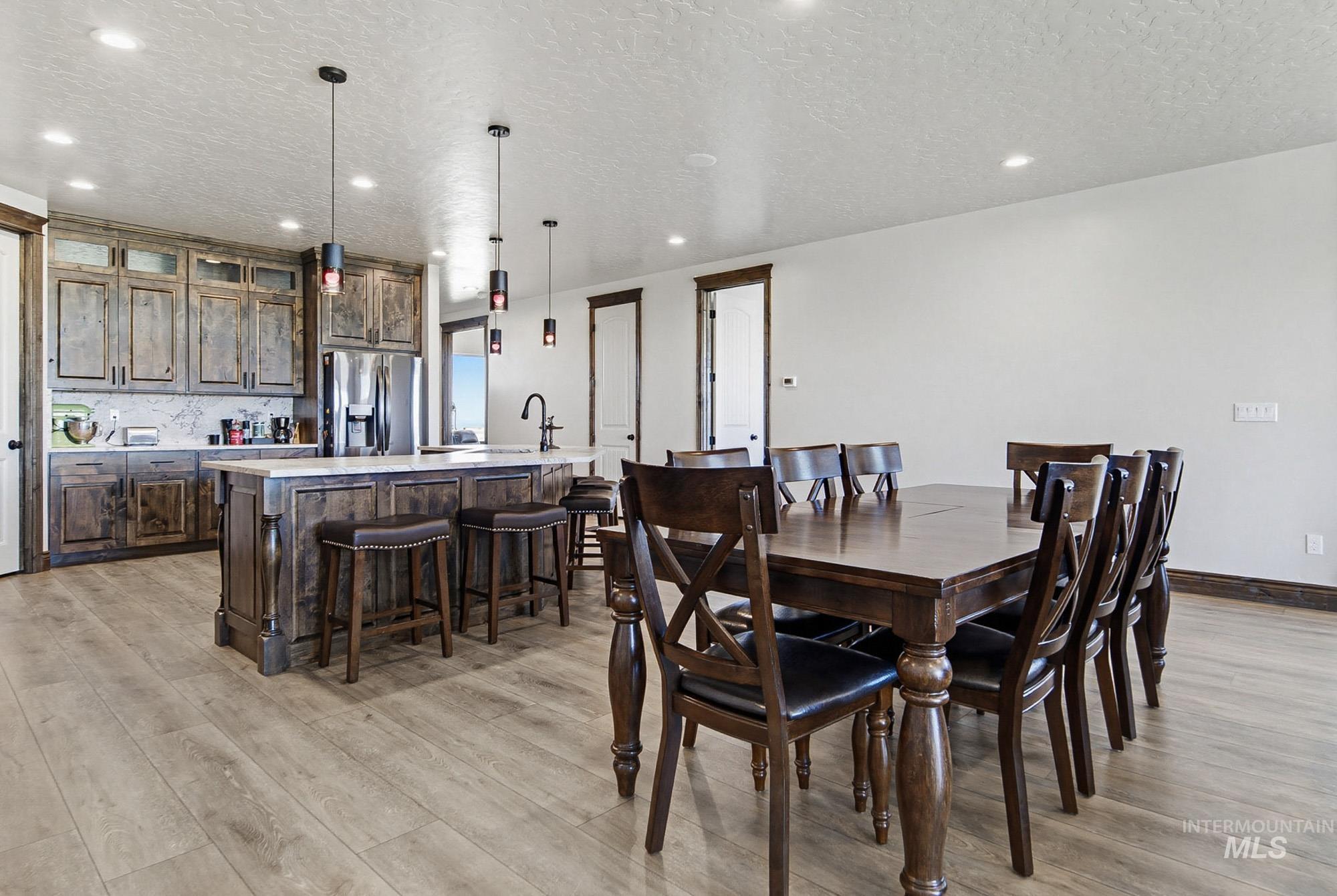 24753 Simplot Boulevard Wilder, ID 83676 - Photo 7 of 47 Dining area with a textured ceiling, light wood-type flooring, and recessed lighting