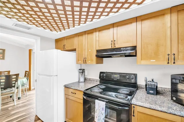 a kitchen with a stove a refrigerator and a microwave