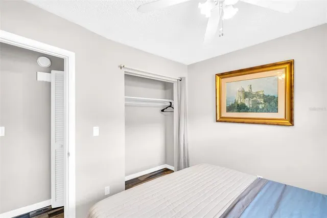 a bedroom with a bed and a painting on the wall