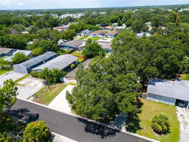 an aerial view of residential houses with outdoor space and street view