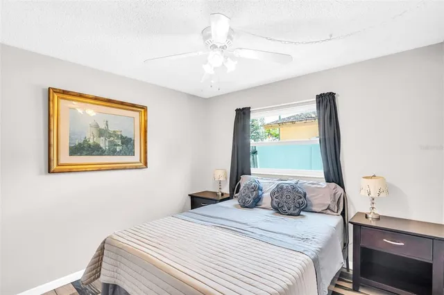 a bedroom with a bed and a painting on the wall