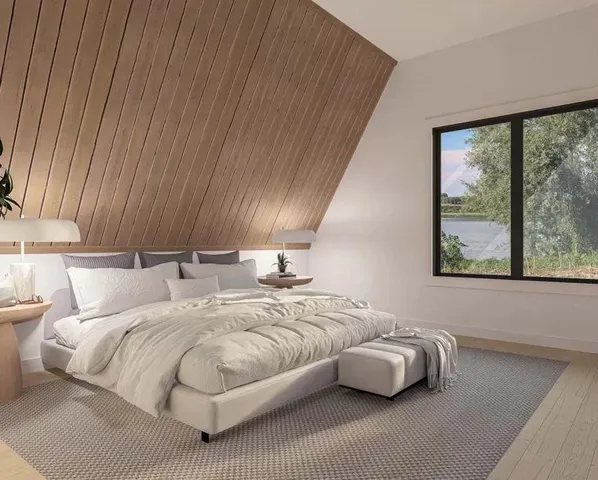 a bedroom with a bed and window