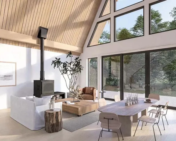 a living room with furniture and a floor to ceiling window