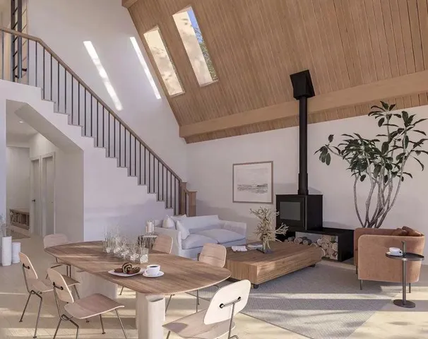 a living room with furniture kitchen view and a potted plant