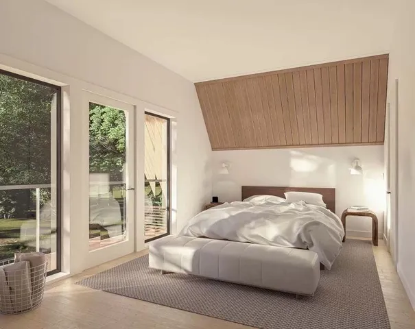 a bedroom with a bed and a large window