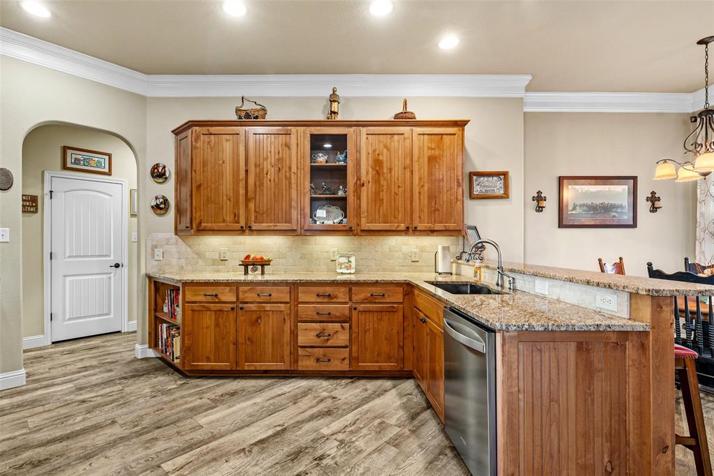 1177 Ronald Road Glen Rose, TX 76043 - Photo 11 of 30 a kitchen with stainless steel appliances granite countertop a sink stove and cabinets
