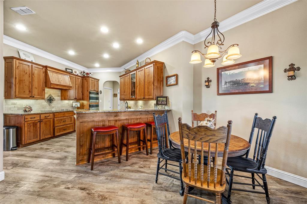 1177 Ronald Road Glen Rose, TX 76043 - Photo 12 of 30 a view of a dining room with furniture and a chandelier